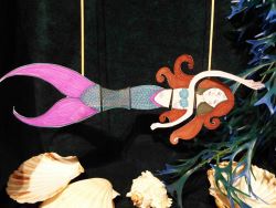 paper cut-out of a mermaid with sea shells