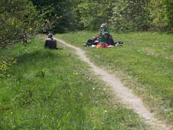 People sat beside a countryside path